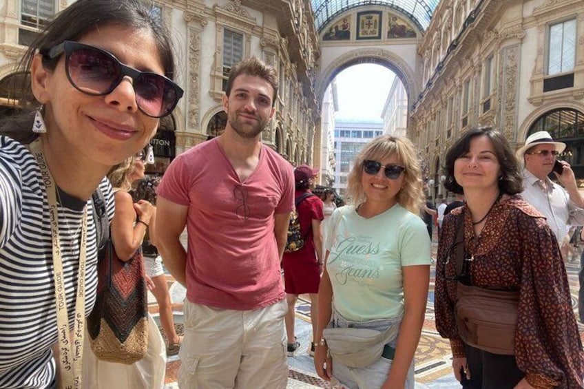 A group of people in a historic building with arches and columns. 3