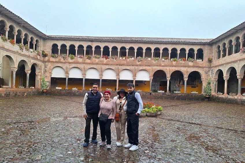 A courtyard with arches and a cobblestone floor. 4