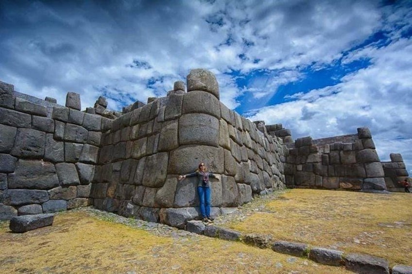 A stone wall with a person standing in front of it. 3