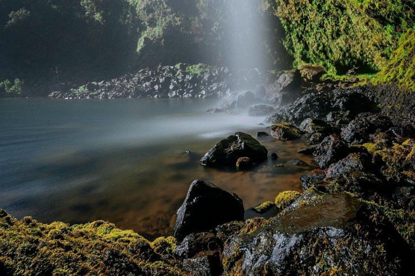 A waterfall, rocks, and a body of water. 3