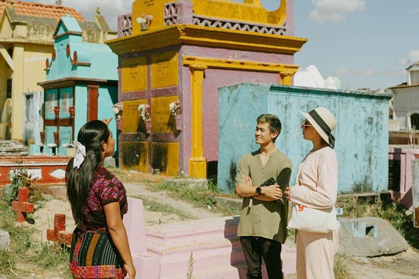 A cemetery with colorful tombs and a clear sky. 2