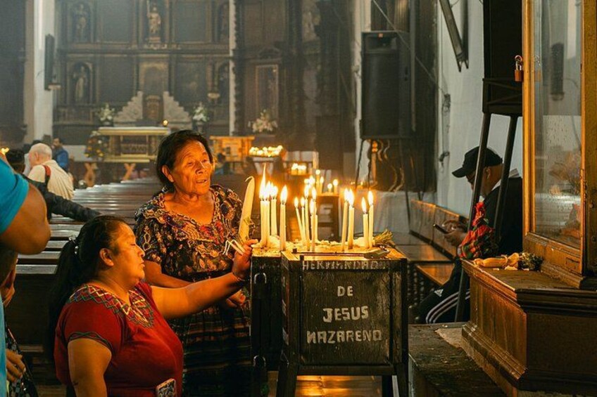 A church interior with a candlelit altar, a woman and a child, and a religious icon. 3