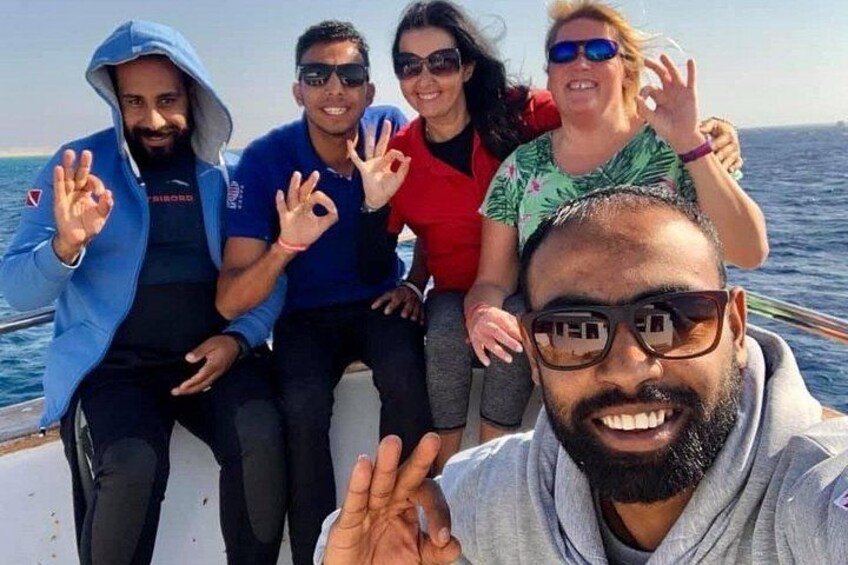 A group of people on a boat with the ocean in the background. 2