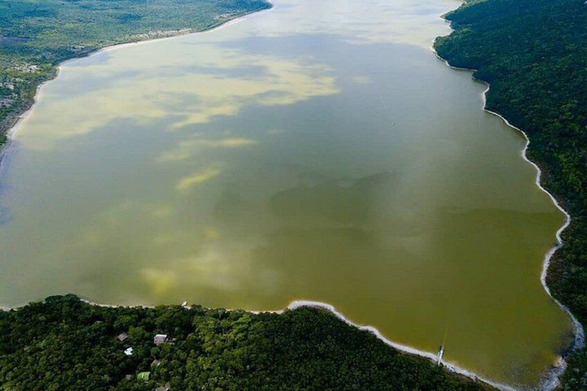 A large body of water surrounded by dense forest. 5
