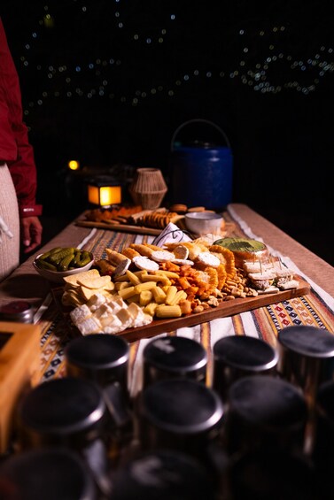 A table with various cheeses, nuts, and fruits. 3