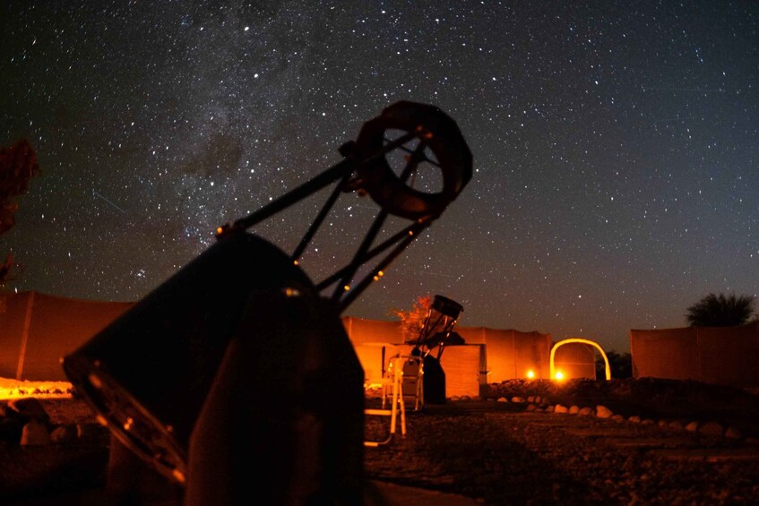 A telescope under a starry night sky. 5