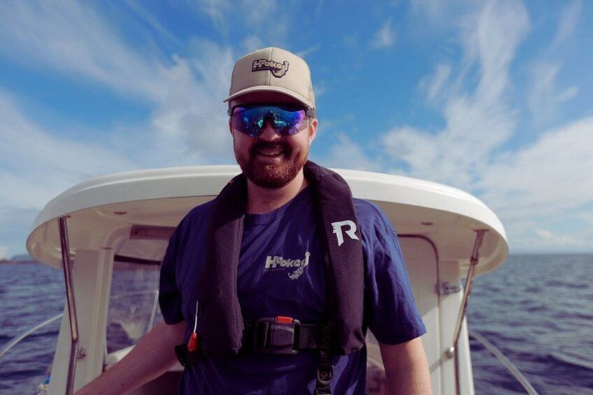 A person on a boat with a clear sky and calm sea. 3
