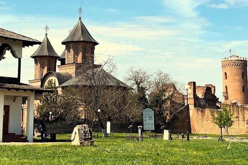 A church with three towers, a cemetery with headstones, and a castle-like structure. 1