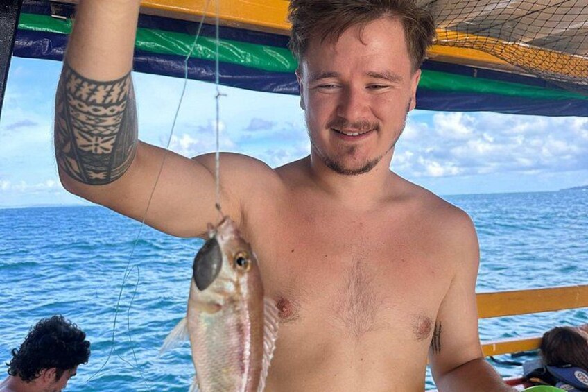 A person holding a fish. 4