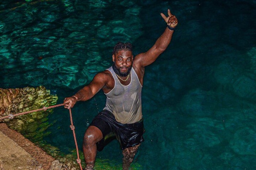 A person in a swimming pool holding a rope. 5