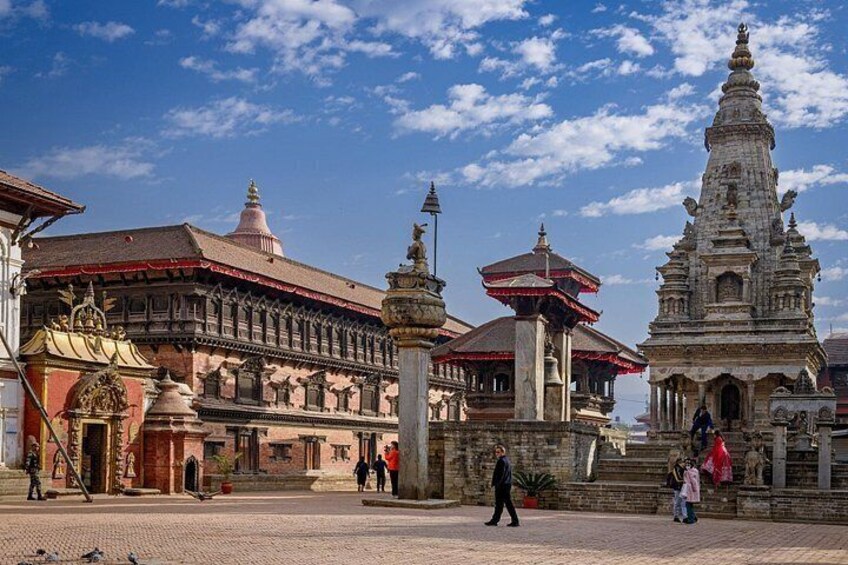 A traditional building with a red roof, a large bell tower, and a smaller pagoda-like structure. 2