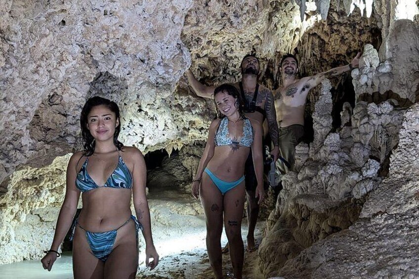 A group of people in a cave with rocky formations. 4