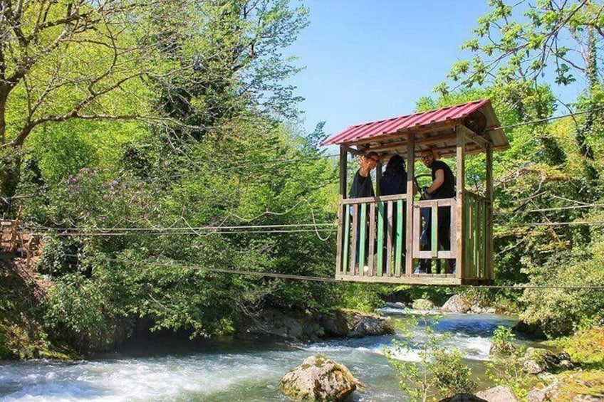 A wooden observation tower over a river surrounded by greenery. 2
