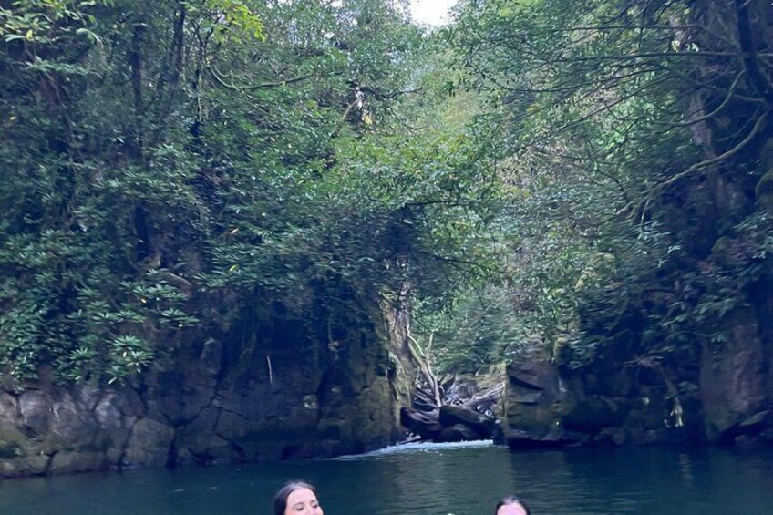 A river flowing through a forested canyon with rocky cliffs and dense foliage. 4