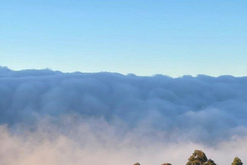 A mountain range with clouds at the base. 2