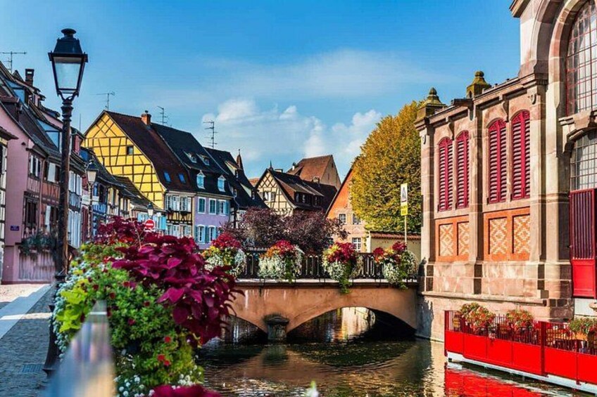 A historic bridge, colorful buildings, and a canal. 2