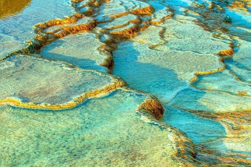 A close-up of mineral deposits with distinct orange and brown edges. 1