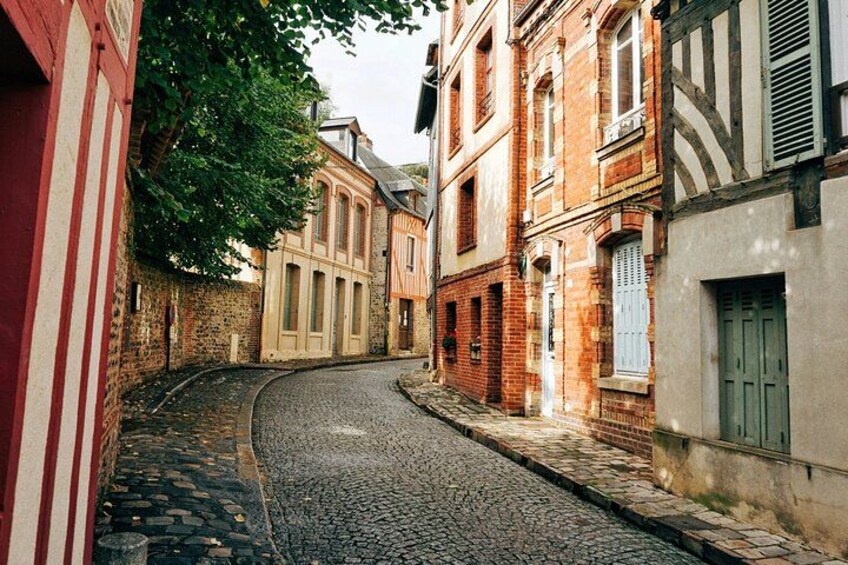 A cobblestone street in a historic European town with traditional half-timbered buildings. 3