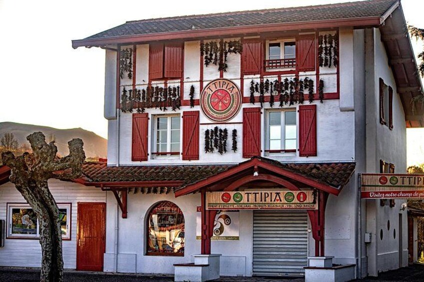 A building with a sign that reads 'TTIPIA' and a red awning. 4