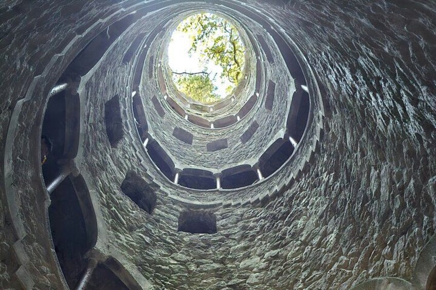 A spiral stone structure with a central opening. 3