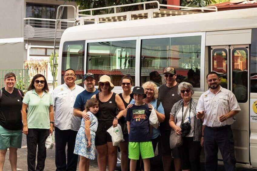 A group of people standing in front of a bus. 2
