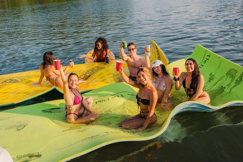 People on inflatable surfboards in a body of water. 2