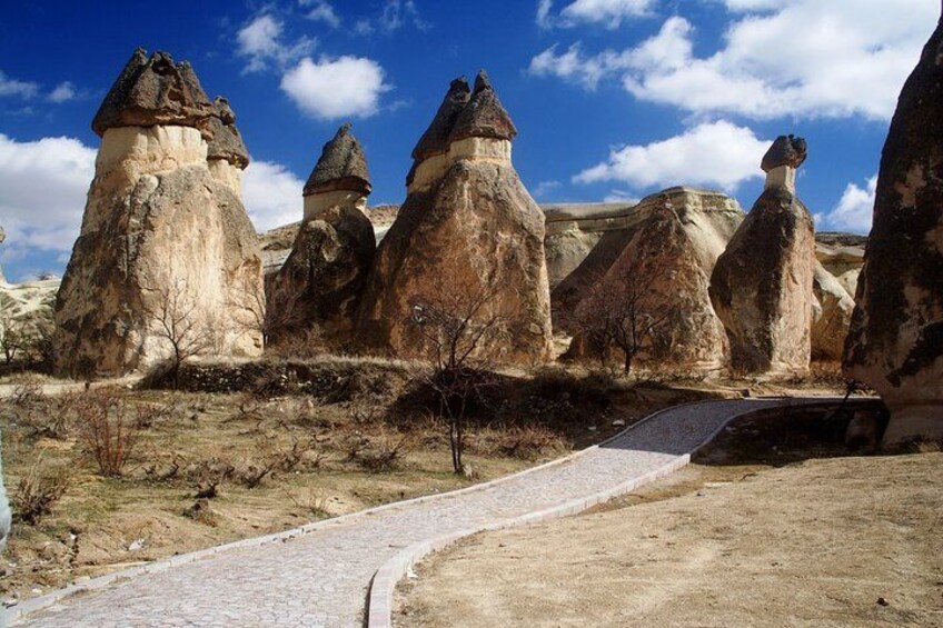 A pathway leading through a landscape with unique rock formations. 2