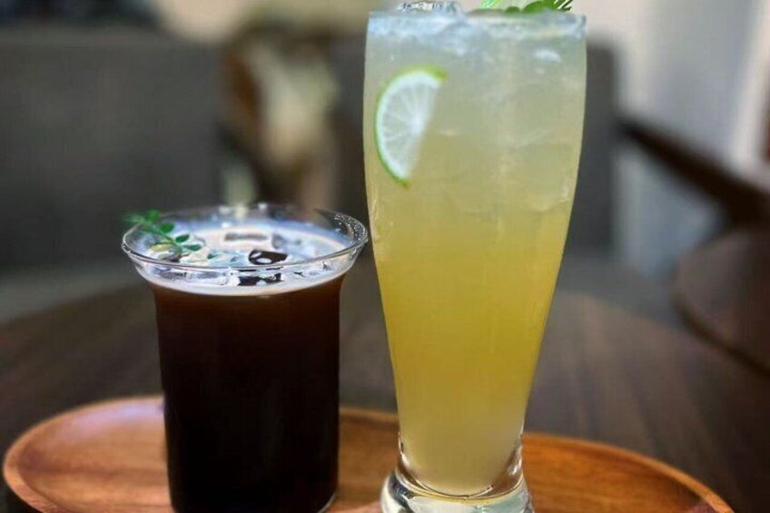 Two glasses of beverages on a wooden tray. 2