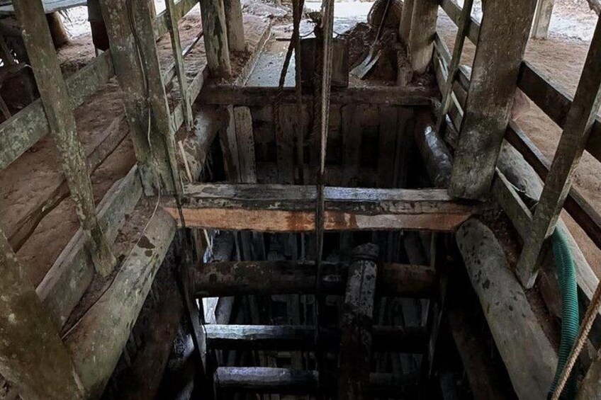A wooden structure with a metal beam and a green hose. 5