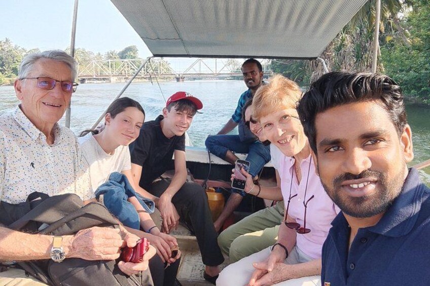A group of people on a boat with a bridge in the background. 1