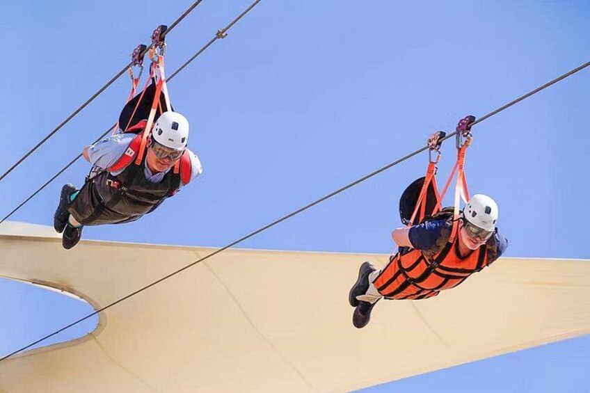 Two individuals bungee jumping from a structure. 2