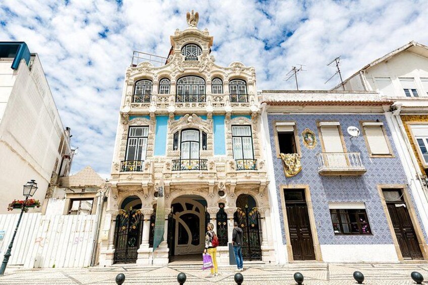 A historic building with ornate architecture, a tiled facade, and a prominent entrance. 4