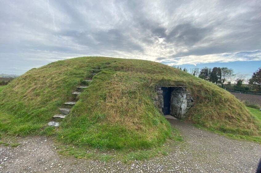 A mound with a stone staircase leading to a cave entrance. 1