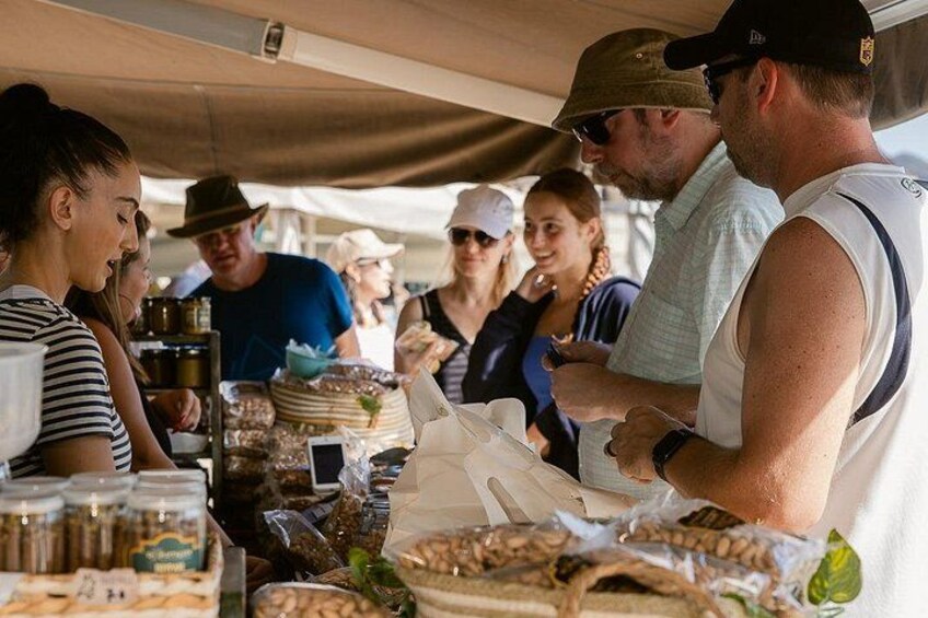 A market stall with various food items and jars. 1