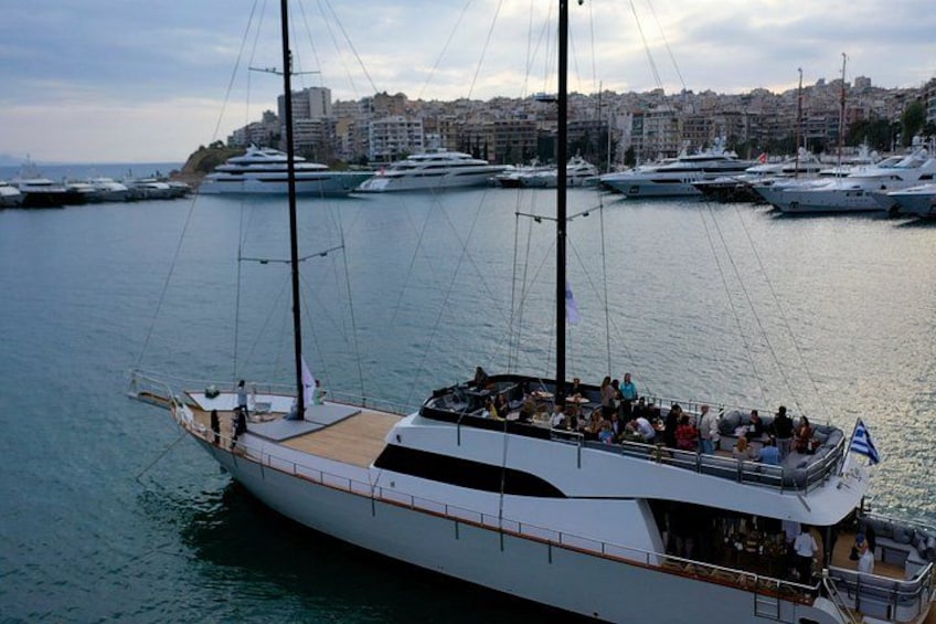 A large yacht docked at a marina with several other yachts in the background. 4