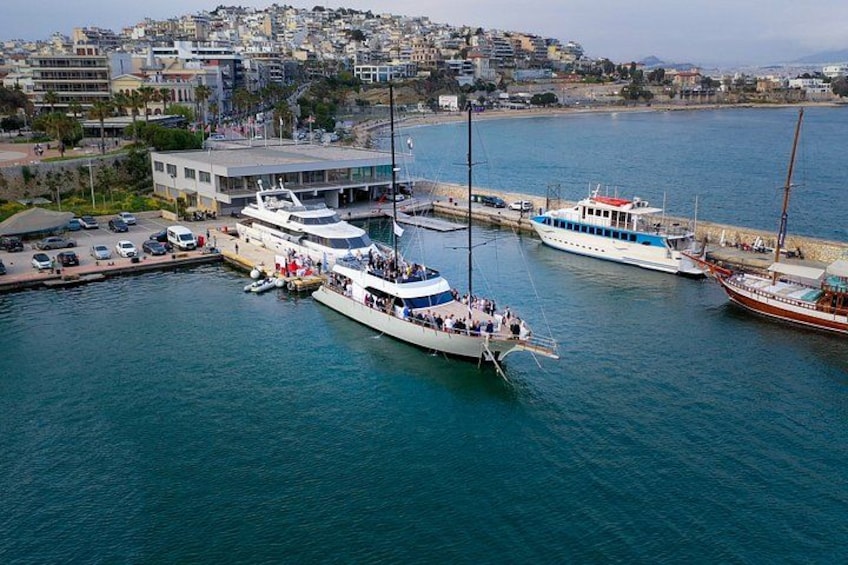A harbor with several boats docked, a building with a sloped roof, and a densely built urban area in the background. 3