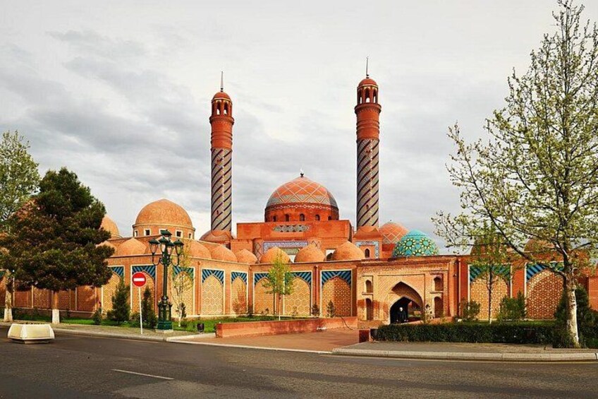 A mosque with two minarets, domes, and a courtyard. 5