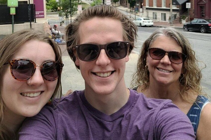 Three people taking a selfie on a city street. 4