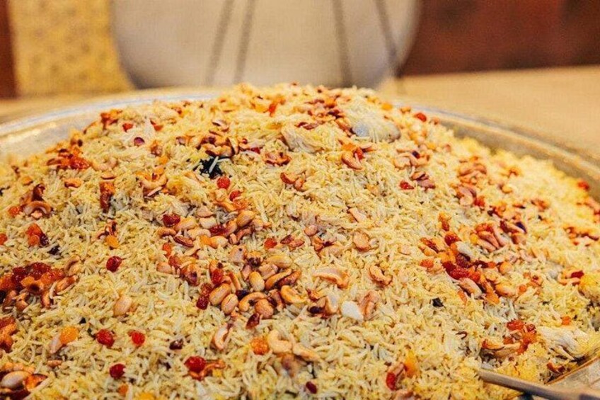 A large serving of rice with nuts and raisins. 4
