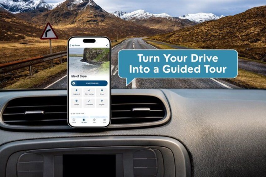 A smartphone mounted on a car dashboard displaying a guided tour app with a scenic mountainous landscape in the background. 1