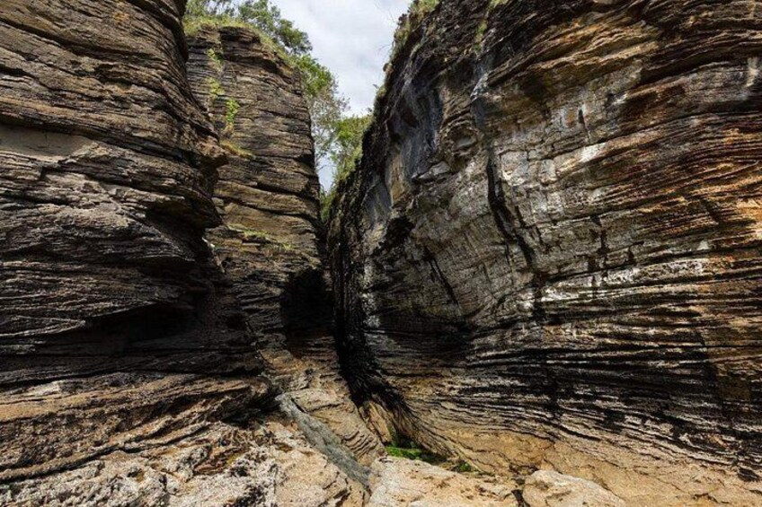 A canyon with layered rock formations. 2