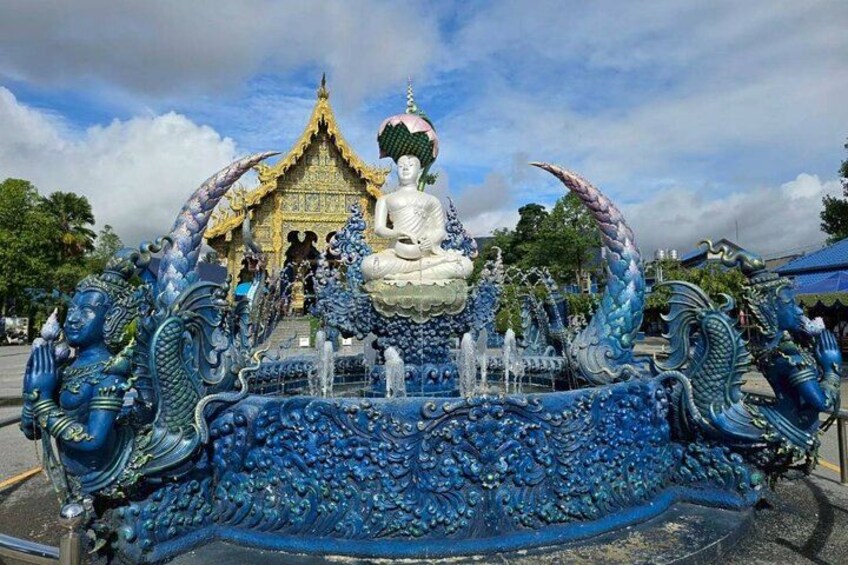 A large Buddha statue surrounded by a blue dragon sculpture. 4