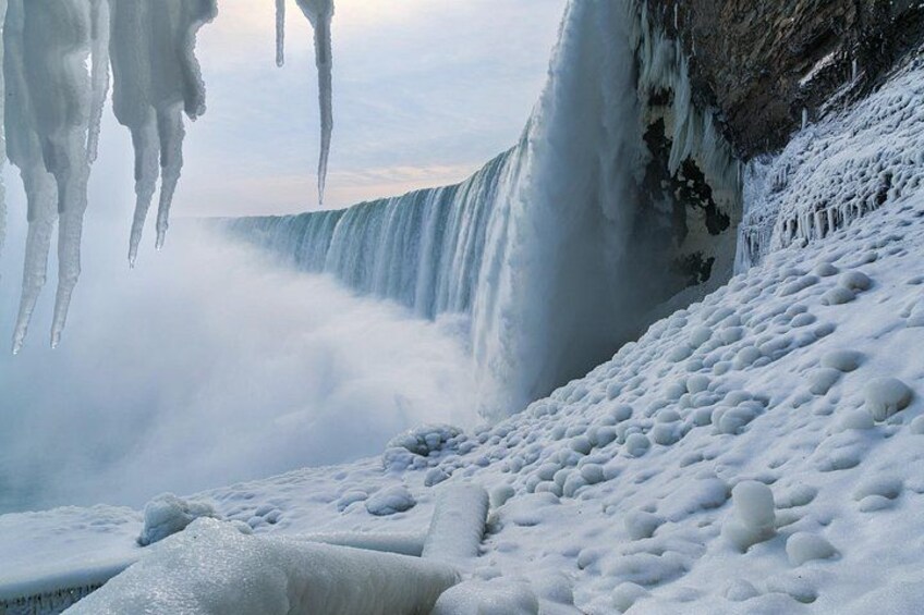 A waterfall surrounded by ice formations. 5