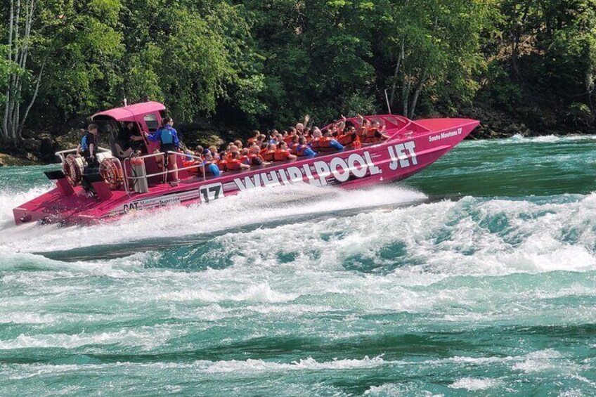A speedboat with passengers on a river. 5