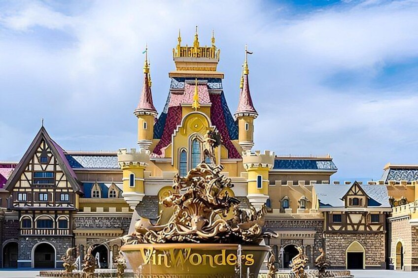 A castle-like building with a golden statue in front. 3