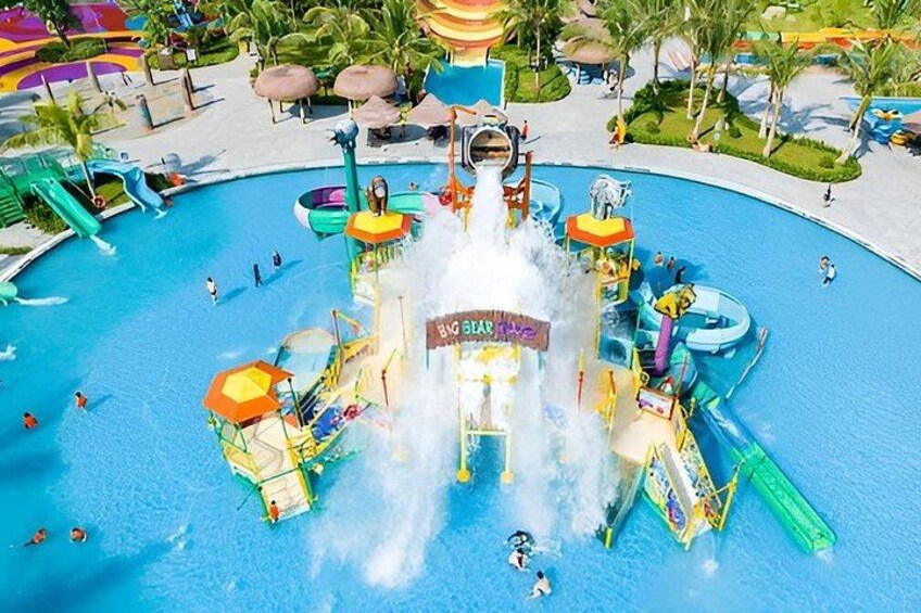 A water park with a central water feature, slides, and a pool. 4