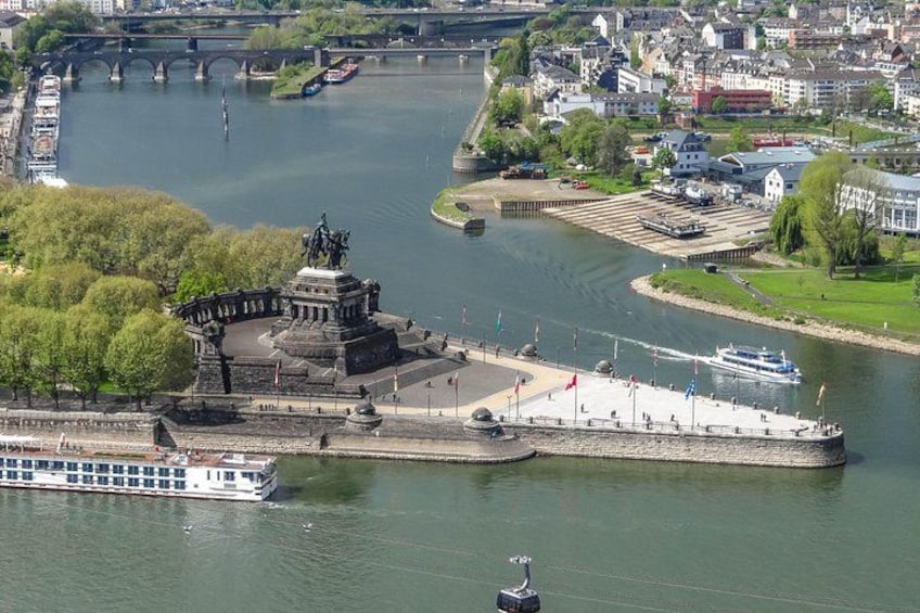 A river with a bridge, a statue, a boat, and a cityscape. 2