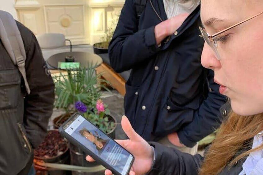 A person holding a smartphone displaying a photo. 1