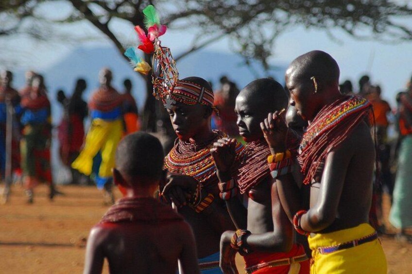 A group of people in traditional attire with colorful beadwork and headpieces. 4
