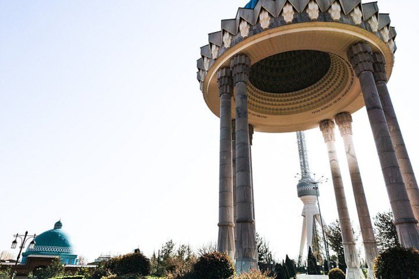 A large, ornate structure with columns and a dome, a tower, and a blue dome in the background. 2